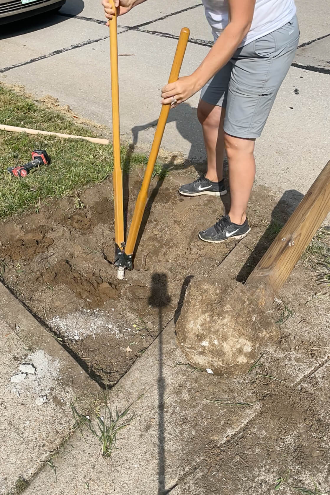 Using a post hole digger for a new mail box. 